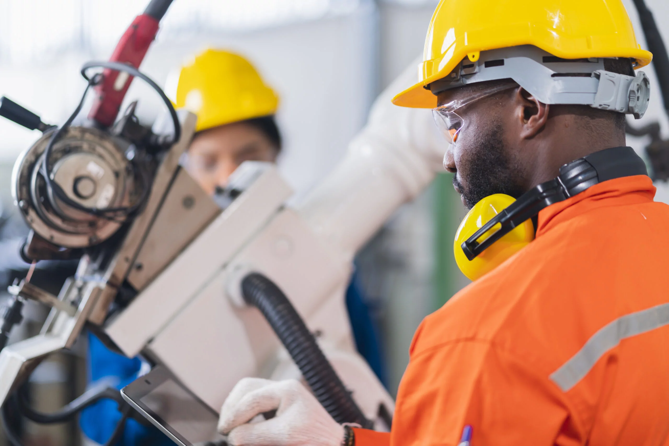 engineer-cooperation-male-female-technician-maintenance-control-relay-robot-arm-system-welding-with-tablet-laptop-control-quality-operate-process-work-heavy-industry-40-manufacturing-factory